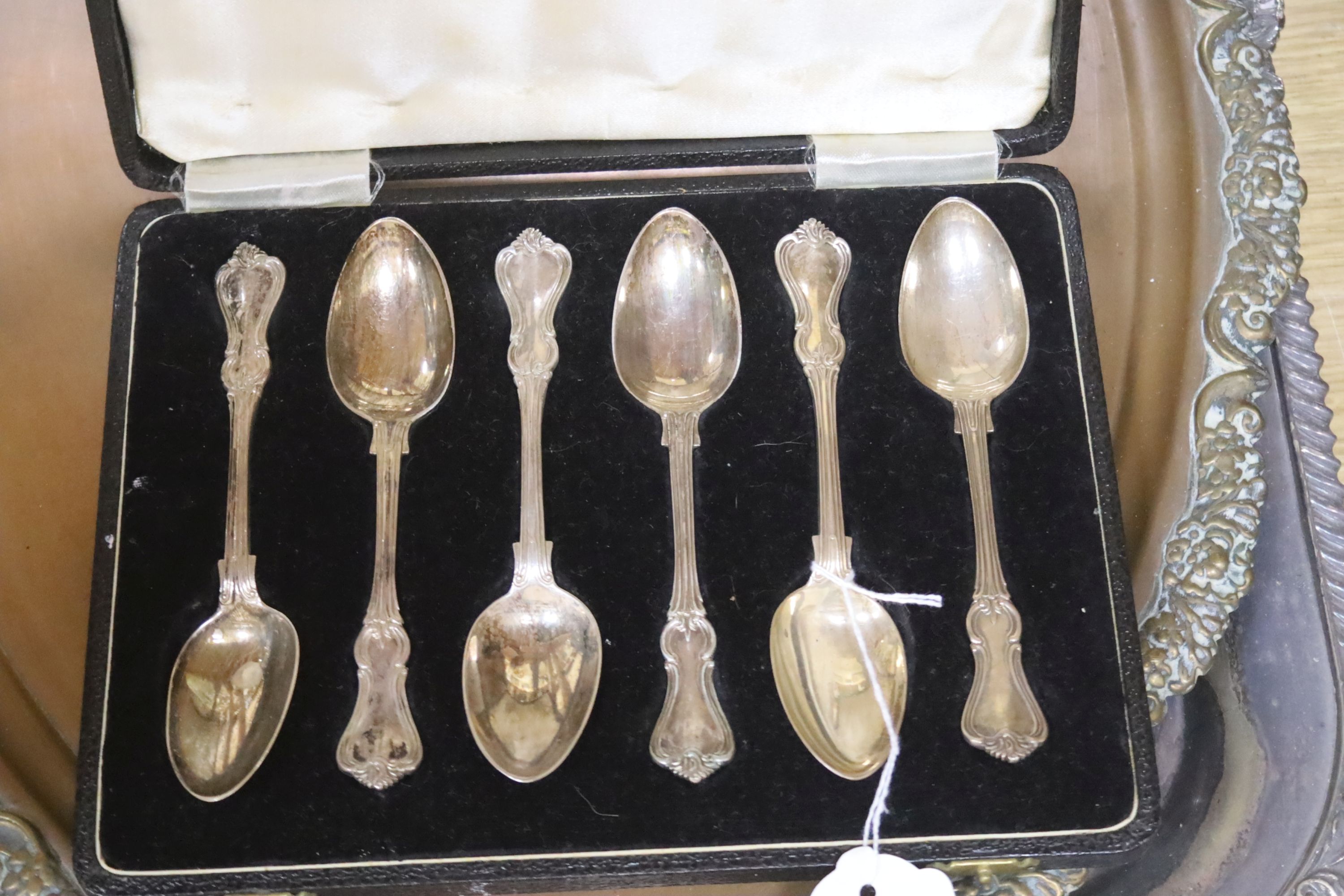 A cased set of six silver spoons, a large rectangular plated tray, an oval tray and a plated Corinthian column lamp